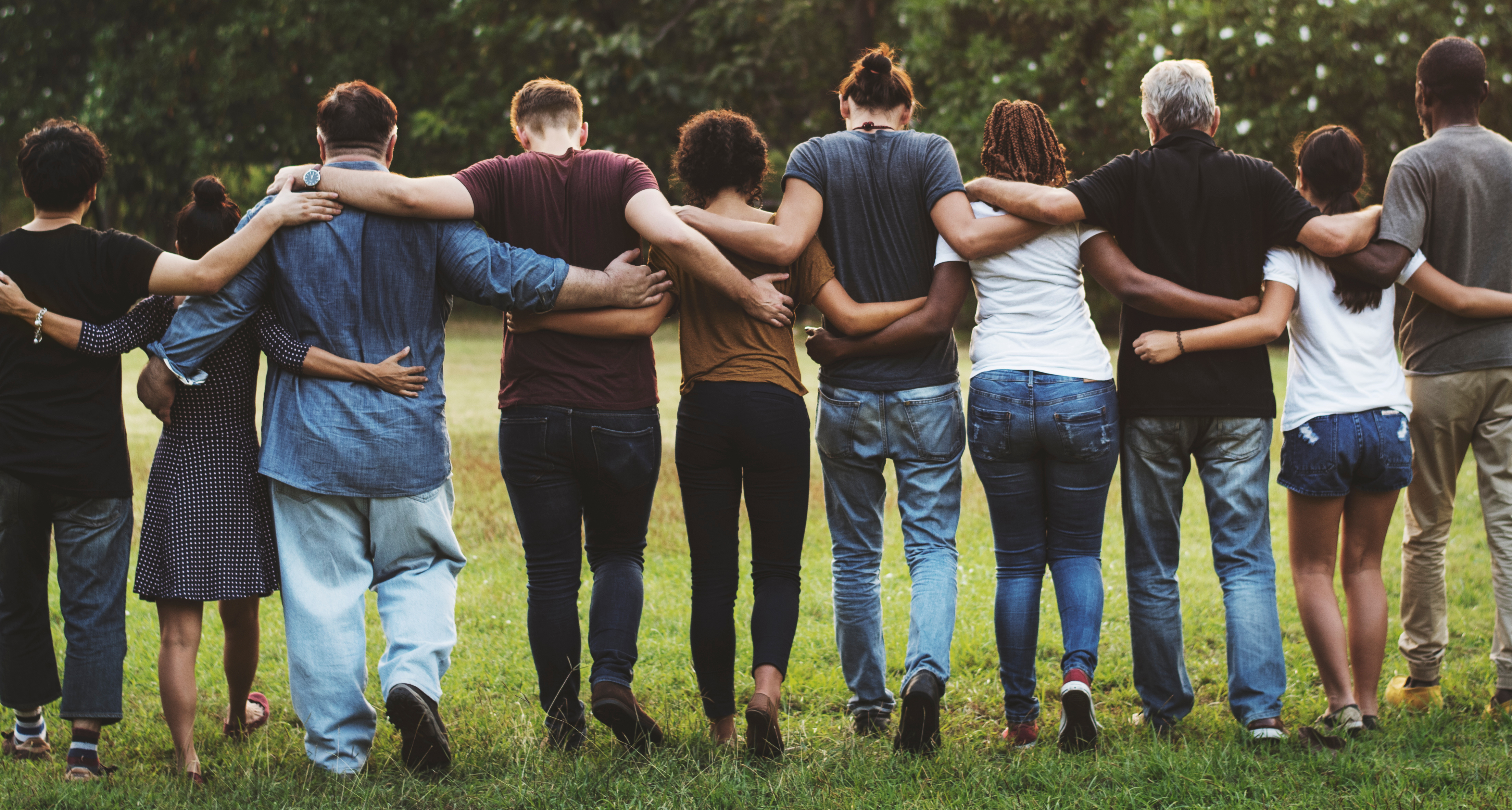 Line of different ethnic groups from behind with hands around each other