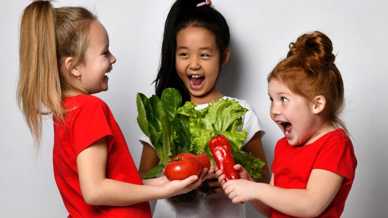 Children holding vegetables